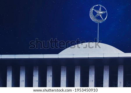 Close up of mosque dome building with moon and star symbol in the night sky background
