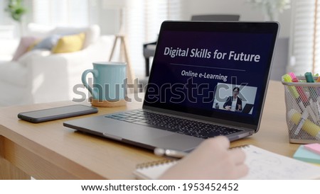 Rear view young asian woman listen watch digital class e-learning online for employee reskill upskill on notebook computer at home office workplace. Business school lesson education for adult people. Royalty-Free Stock Photo #1953452452