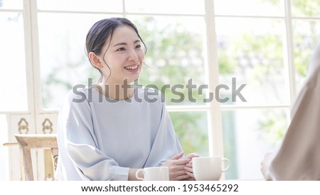 Asian women talking at home