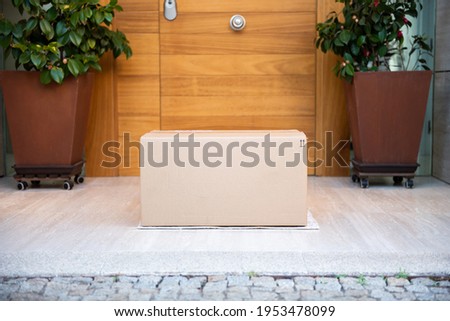 parcel on door mat near entrance Royalty-Free Stock Photo #1953478099