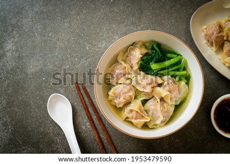 pork wonton soup or pork dumplings soup with vegetable - Asian food style Royalty-Free Stock Photo #1953479590
