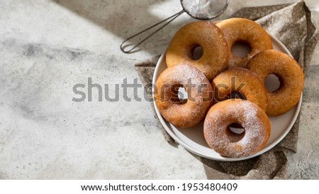 Homemade donuts on grey cement background. Food concept. Copy space. Royalty-Free Stock Photo #1953480409