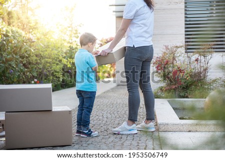 adult delivering several packages parcels to a small child. Deli