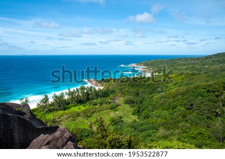 Aerial view of the tropical coastline with horizon over the Indian Ocean and pristine jungleGrand Anse, La Digue Island, Seychelles