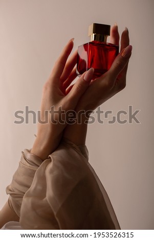 Perfume in a beautiful female hand Royalty-Free Stock Photo #1953526315