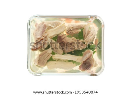 Delicious homemade aspic with meat in glass bowl isolated on white, top view