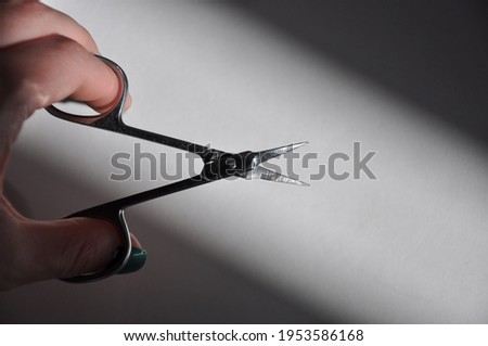 Manicure scabbard. Sharp scissors. Cut the cuticle.