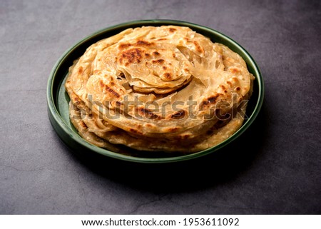 Laccha Paratha is a layered Puffed Flatbread with lots of ghee or oil Royalty-Free Stock Photo #1953611092
