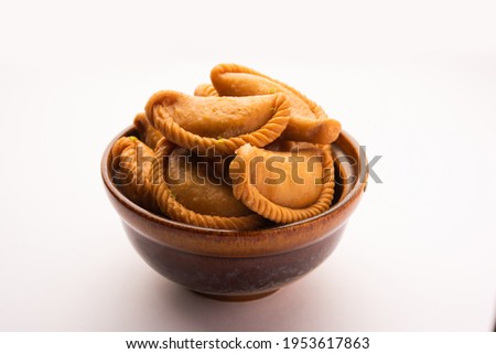 Gujiya or gujia or karanji - sweet dumplings made during the festival of holi and diwali, served in a plate. selective focus Royalty-Free Stock Photo #1953617863