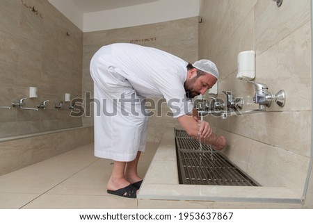 A Muslim takes ablution for prayer. Islamic religious rite Royalty-Free Stock Photo #1953637867