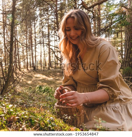 Girl with a basket in the forest smiling.European girl, Latvian. Picture was taken in Salacgriva.