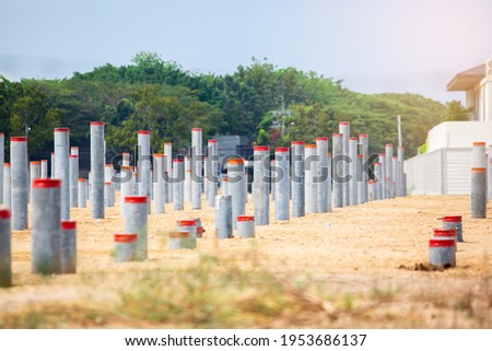 Selective focus to many round prestressed concrete piles that have been hammered into the ground in a large project. Concrete Pile for Foundation of Building. construction foundation work.
