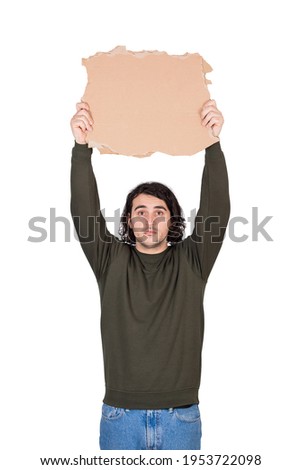 Man with hands outstretched holding a blank cardboard sheet over head as participates in a street demonstration or protest. Blank banner for advertising and messages. Person isolated on white
