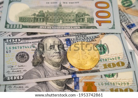 Bitcoin on dollar banknotes. investing in cryptocurrency. playing on the stock exchange. 