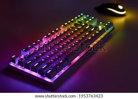RGB gaming keyboard. Bright colorful keyboard with mouse, neon light. Mechanical keyboard with RGB light. Royalty-Free Stock Photo #1953763423