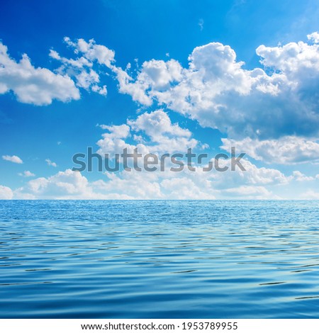 Photo of beautiful blue clear bay waves with sky and clouds