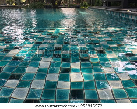close up view of water in swimming pool finished with blue mosaic