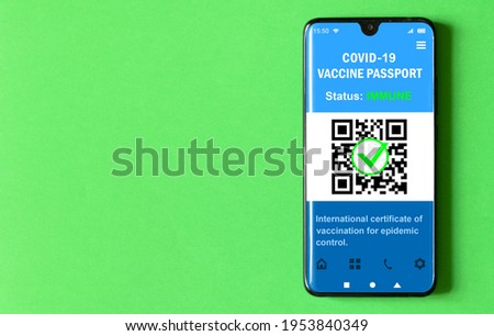 Digital passport of COVID-19 vaccination in mobile phone on green background, certificate app in smartphone screen for travel. Coronavirus vaccine pass as proof of corona virus immunization.