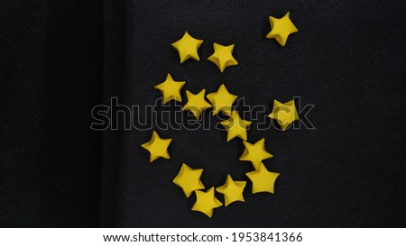 yellow paper stars on black background