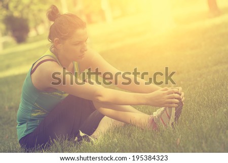 Vintage photo of woman warming up before running