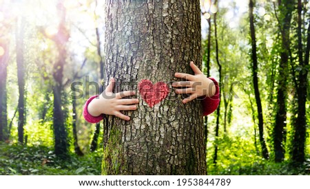 Tree Hugging - Love Nature - Child Hug The Trunk With Red Heart Shape Royalty-Free Stock Photo #1953844789