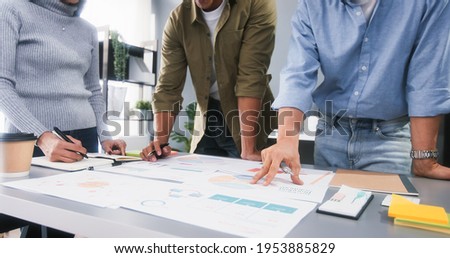 Young Asian business financial team work together in project brainstorm meeting. Cooperate teamwork, strategy planning, small business startup company, or office coworker collaborate concept Royalty-Free Stock Photo #1953885829