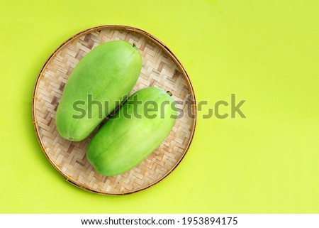 Winter melon in basket on green background. Top view