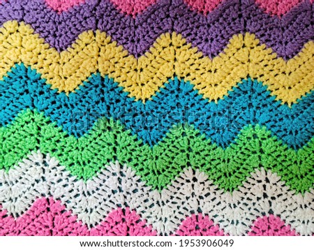 Colorful yarn in crochet zigzag pattern background