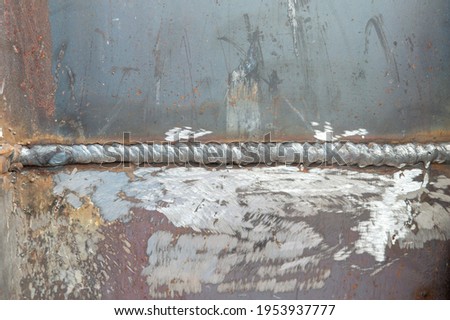 Welding steel beams completed in process shielded metal arc welding.close up weld on a steel beams for a new heat line.The welded joint on a steel beams,high pressure line
