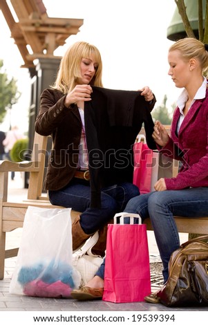 Two young girls shopping in the sunny weather