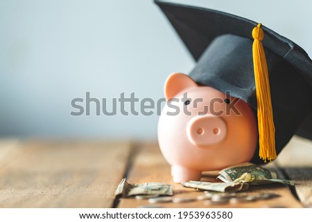 piggy bank With Graduation Cap on old wood,Money saving concept. 