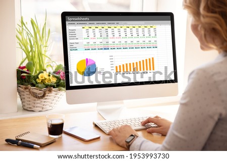 Woman working with spreadsheets on desktop computer Royalty-Free Stock Photo #1953993730