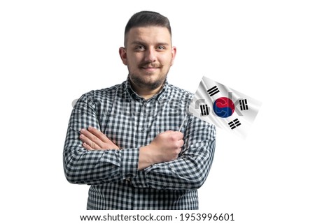 White guy holding a flag of South Korea smiling confident with crossed arms isolated on a white background.