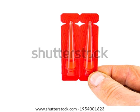 Red plastic ampoules of animal veterinary medicine. A medicine for ticks and fleas. Fleas and ticks in pets. Vaccination of cats and dogs. Worms in cats and dogs. Veterinary medicine. Care.