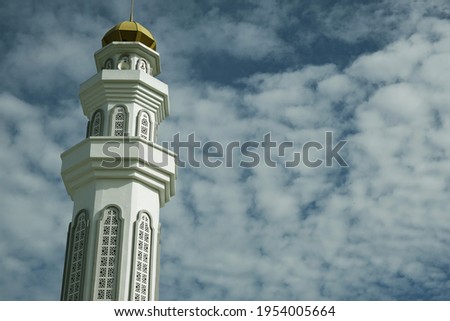 A picture with noise effect of minaret and beautiful cloud as background