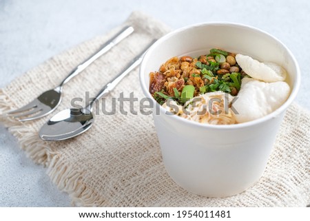 Bubur ayam, Indonesian rice porridge with shredded chicken over white background