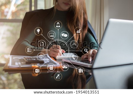 Women work on laptop on the table at the office with information documents.