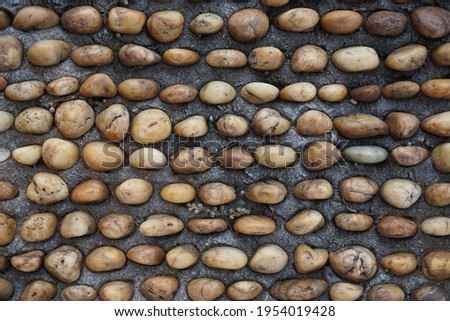 Natural round stone floor texture for background.