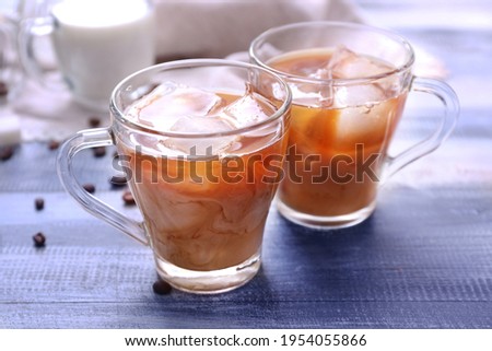 Cups of tasty iced coffee on table