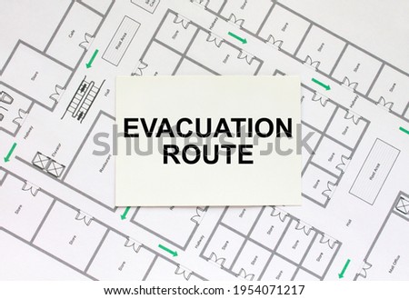 Business card with text Evacuation Plan on a construction drawing. Concept photo