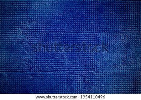 A dark blue background with vignetting and irregular dotted texture. technological or dark background