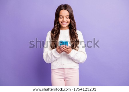 Photo of young beautiful smiling pretty good mood positive girl read message in phone isolated on violet color background