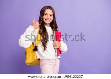 Photo of young pretty good mood cheerful happy smiling girl showing thumb up hold notebooks isolated on violet color background Royalty-Free Stock Photo #1954123237