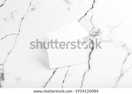 Photo of white business cards on white marble. Template for branding identity isolated on marble background. Marble premium luxury mock-up. Business Card isolated on marble stone. 
