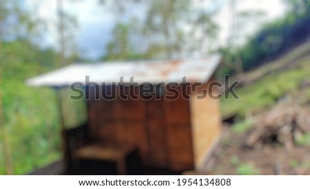 defocused abstract background of a small bamboo huts with tin roofs on the island of Flores, Indonesia