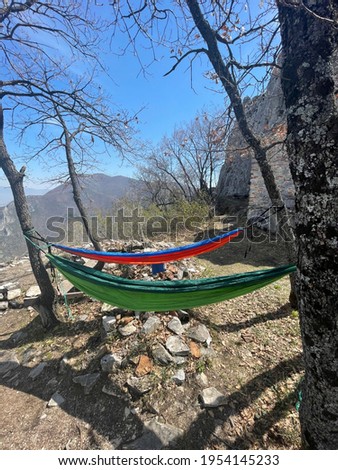 Green and orange hammocks hanging on trees on Sv.Nedela, Matka. Relaxing and distancing 