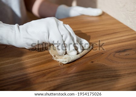 Coating wood with oil. Impregnation of wooden countertops. Close-up Royalty-Free Stock Photo #1954175026