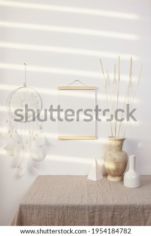 Poster hanger mockup with dreamcatcher and vase