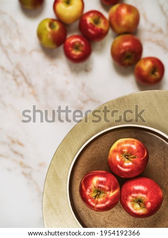 Flat lay composition of fresh ripe red apples on round table.Space for text.