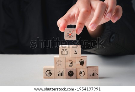 Hand arranging wood block stacking with icon action plan, Goal and target, success and business target concept, project management, company strategy development.